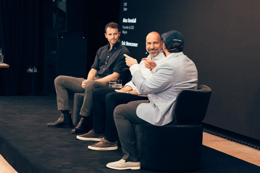Dara Khosrowshahi and Alex Kendall in conversation with Eric Newcomer on the CVL1 stage